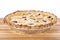 Closeup of Cooked Cherry Pie with Lattice on a Wood Cutting Board