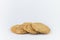 Closeup cookies are arranged in multiple pieces, stacked together, and the cookies are brown and the image has blank space beside