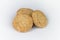 Closeup cookies are arranged in multiple pieces, stacked together, and the cookies are brown and the image has blank space beside