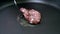 Closeup cooking pork burger in a pan,slow motion movement