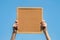 Closeup cork board in hand of woman with sun light