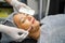 Closeup cosmetologist use cosmetic brush applying facial jelly\'s gel on woman client face in beauty clinic