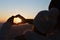 Closeup of couple making heart shape with hands and sunrise background, Couple in love, Focus on hands, Man and woman tourists in