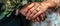 A Closeup Of A Couples Hands Exchanging Wedding Rings With The Phrase Forever United