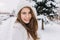 Closeup cozy winter portrait with snowflakes on long brunette hair enjoying snow winter time on street in city. Warm