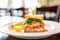 closeup of crab cake sandwich with lettuce in a bistro