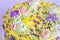 Closeup cream floral decoration on colorful cake