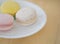 Closeup Cream macaroons , macarons on wooden background.