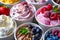 Closeup Of Creamy Ice Cream Cups With Various Flavors And Fresh Fruit Toppings