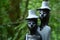 Closeup of creative human sculptures in a green forest