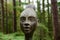 Closeup of creative human sculptures in a green forest