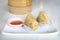 Closeup crispy deep fried taro dumpling in white plate with sweet sauce in dim sum set, Chinese restaurant food