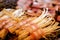 Closeup and crop bacons with Enoki mushroom skewers grilling on stove and blurred background