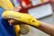 Closeup and crop hand of human touch and holding yellow python on blurry background