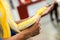 Closeup and crop hand of human touch and holding yellow python on blurry background