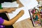 Closeup and crop hands of student holding crayon draw and painting on white paper