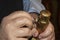 Closeup crop of man opening champagne bottle - removing wrapping foil