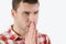 Closeup croped portrait young man praying hands clasped hoping for best asking for forgiveness or miracle on white background