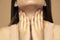 Closeup cropped image of a woman has a thyroid disorder. Sore throat. Inflamed glands