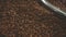 Closeup cropped shot of a traditional roaster mixing freshly roasted coffee beans