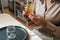 Closeup cropped shot of unrecognizable female artisan tearing off piece of beeswax to create wick for handmade candle at