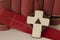 Closeup of a cross and bookmark with a background of books