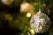 Closeup Crystal ball Decorated on Pine Tree on Christmas night with blurry background and bokeh of Christmas lighting