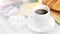 Closeup cup aromatic black coffee and appetizing tasty breakfast meal surrounded by natural light