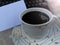 Closeup of a cup of black coffee with blank white notepaper and part of old typewriter keyboard. Copy space.