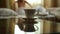 Closeup cup of hot tea or coffee, young woman undresses and goes to bed at night. blurred focus