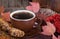 Closeup of a Cup of Steaming Coffee and Raisin Cookies