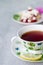 Closeup on cup of tea with sweet cake on wooden table