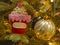 Closeup Cupcake and ball ornament on Christmas tree.