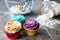 Closeup of cupcakes in front of kitchen utensils