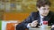 Closeup Curly Schoolboy Eat Porridge and Move in Cafeteria