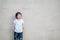 Closeup cute asian kid look at the space on marble stone wall textured background