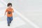 Closeup cute asian kid walk across street on the crosswalk textured background with copy space
