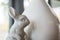 Closeup cute cement rabbit statue for decorate in coffee shop background under window light