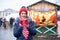 Closeup of cute lovely girl in red hat drinking hot coffee outdoors in winter snow day. standing at the street and drinking hot