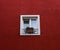 Closeup of a cute window on a red wall with a flower on the fence