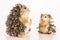 Closeup of a cute wooden hedgehog and a squirrel toy isolated on a white background