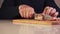 Closeup of cutting chopping a piece of bacon into smaller pieces. Closeup of male hands slicing a piece of bacon.