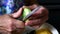 Closeup cutting cucumber peels with knife in wrinkled hands of senior woman