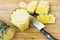 Closeup cutting a pineapple on wooden background