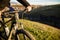 Closeup of cyclist hand on handlebar. Unrecognizable sportsman riding his bicycle on sunny spring day.