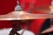 Closeup cymbal with drumkit partly visible blurry background, studio equipment concept
