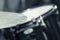 Closeup cymbal with drumkit partly visible blurry background, studio equipment concept