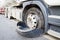 Closeup damaged 18 wheeler semi truck burst tires by highway str