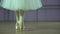 Closeup of dancing legs of ballerina wearing white pointes