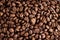 Closeup of dark coffee arabica beans texture. Caffeine aroma. Pile of scented black grains